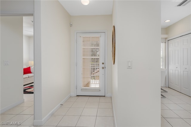 entryway with light tile patterned flooring