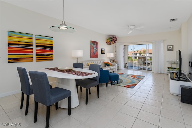 tiled dining space featuring ceiling fan