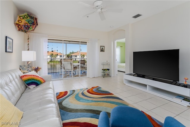 tiled living room with ceiling fan