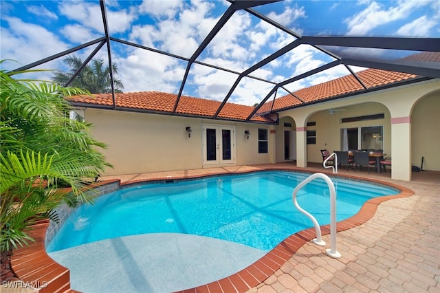 view of swimming pool featuring french doors, a patio area, ceiling fan, and a lanai