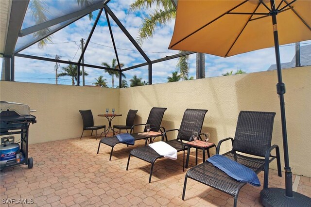 view of patio / terrace featuring area for grilling and a lanai