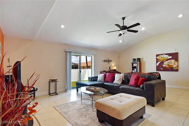 living room with ceiling fan, lofted ceiling, and light tile patterned floors