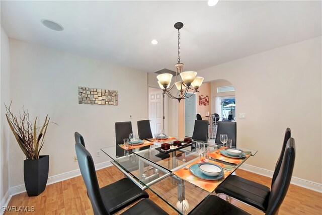 dining space with an inviting chandelier and light wood-type flooring