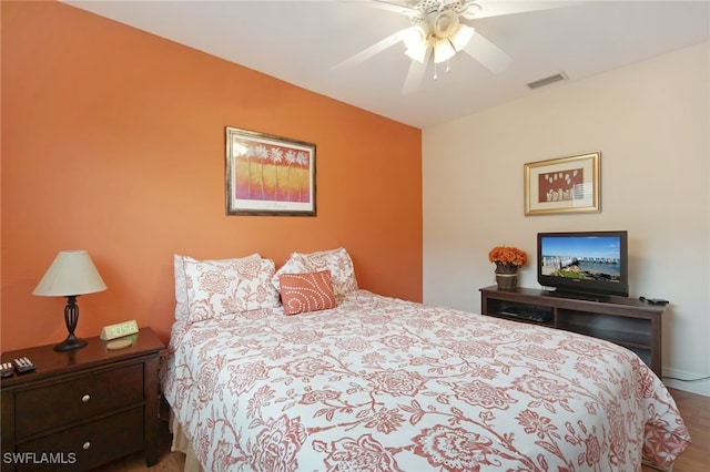 bedroom with ceiling fan and hardwood / wood-style floors