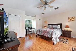 bedroom featuring ceiling fan, wood-type flooring, and lofted ceiling