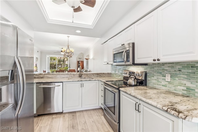 kitchen featuring appliances with stainless steel finishes, white cabinetry, and sink