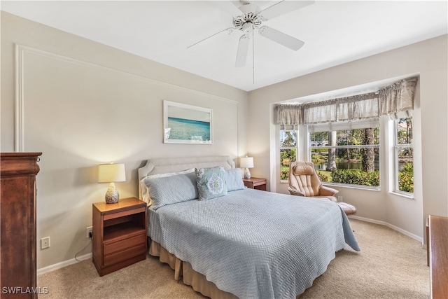 bedroom with light carpet and ceiling fan