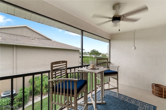 sunroom / solarium featuring ceiling fan