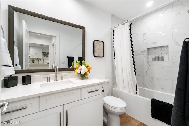 full bathroom featuring shower / bath combo with shower curtain, vanity, and toilet