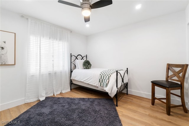 bedroom featuring ceiling fan and light hardwood / wood-style floors