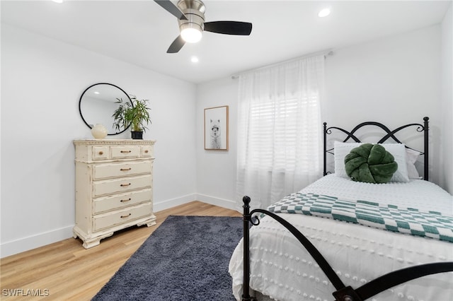 bedroom with ceiling fan and light hardwood / wood-style floors