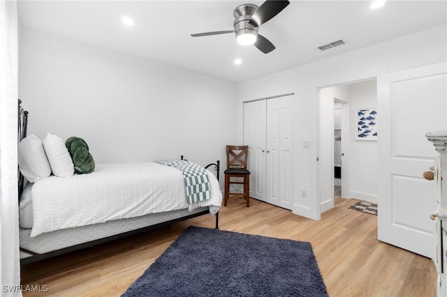 bedroom featuring a closet, ceiling fan, and light hardwood / wood-style flooring