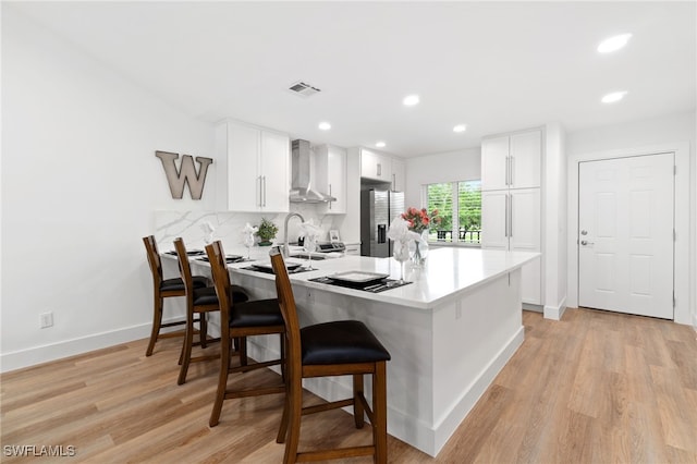 kitchen with a kitchen breakfast bar, kitchen peninsula, and white cabinets