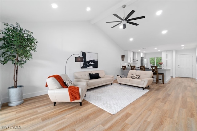 living room featuring beamed ceiling, light hardwood / wood-style floors, high vaulted ceiling, and ceiling fan