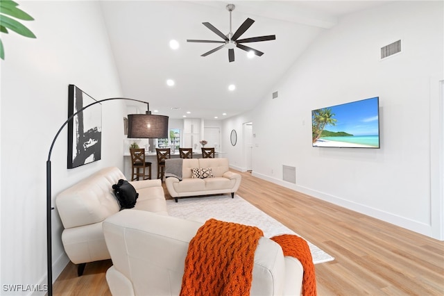 living room featuring beamed ceiling, ceiling fan, high vaulted ceiling, and hardwood / wood-style flooring