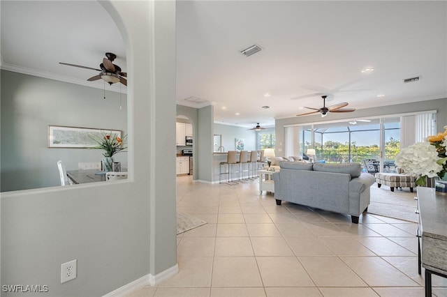 tiled living room featuring crown molding