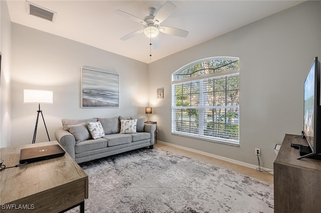 living room featuring tile patterned flooring and ceiling fan