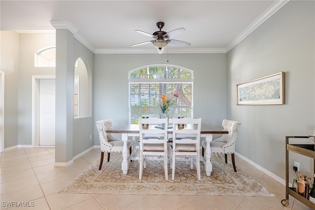 dining area with crown molding, ceiling fan, and light tile patterned floors