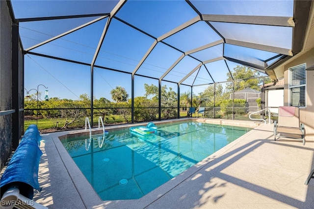 view of pool with a patio area and a lanai