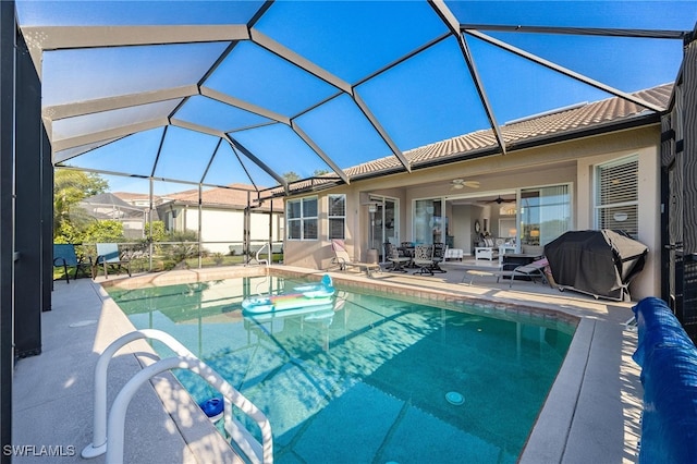 view of pool featuring a lanai, ceiling fan, a patio area, and a grill