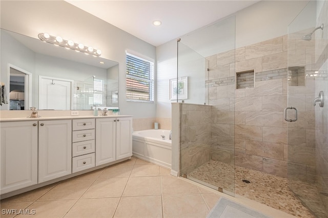 bathroom featuring tile patterned flooring, vanity, and separate shower and tub