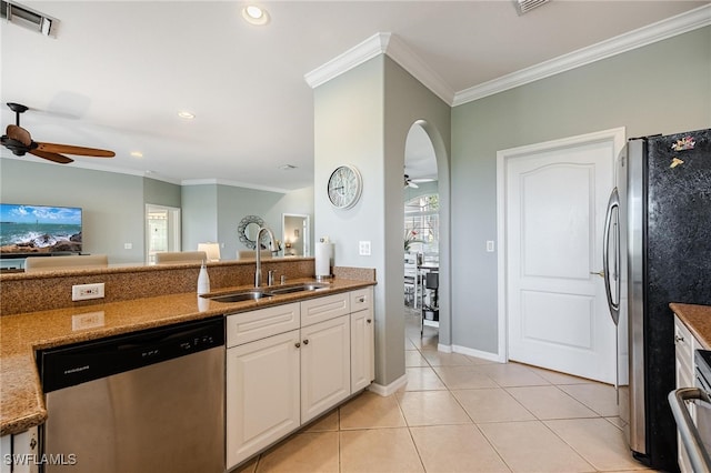 kitchen featuring sink, stainless steel appliances, light tile patterned floors, crown molding, and white cabinets