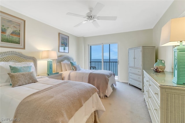 bedroom featuring access to outside, ceiling fan, a water view, and light colored carpet