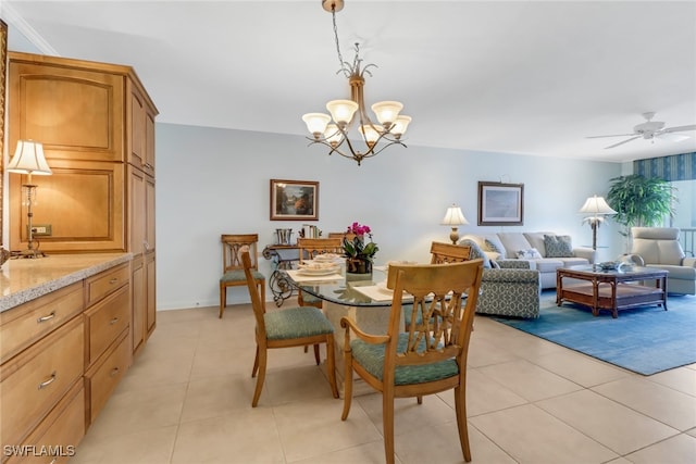 dining area with light tile patterned floors and ceiling fan with notable chandelier