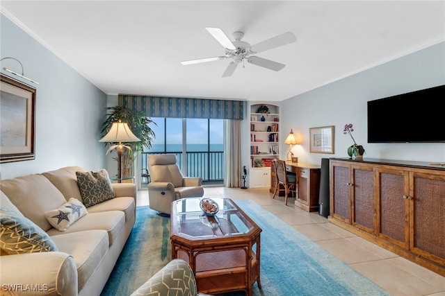 tiled living room featuring ceiling fan and ornamental molding