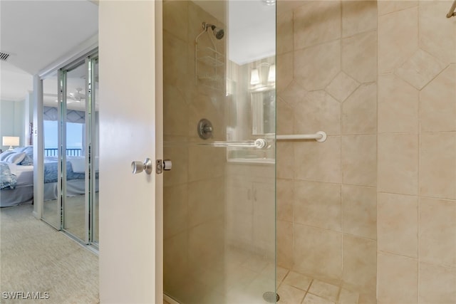 bathroom featuring a shower with door