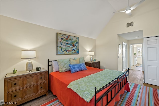 bedroom with high vaulted ceiling, visible vents, ceiling fan, and wood finished floors