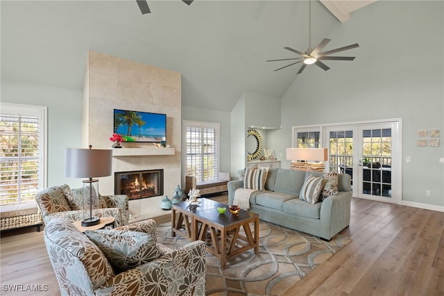 living area featuring a ceiling fan, french doors, and wood finished floors