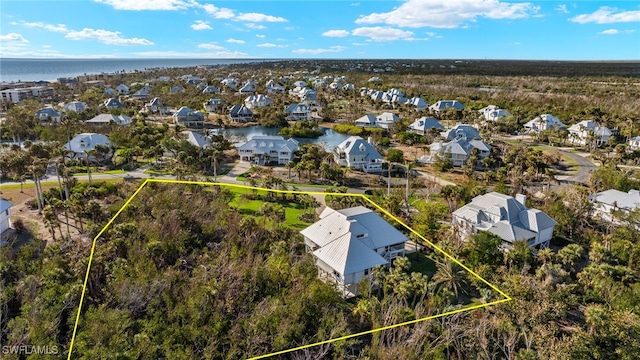 drone / aerial view featuring a residential view and a water view