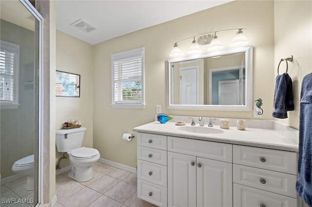 bathroom featuring toilet, visible vents, baseboards, vanity, and tile patterned floors