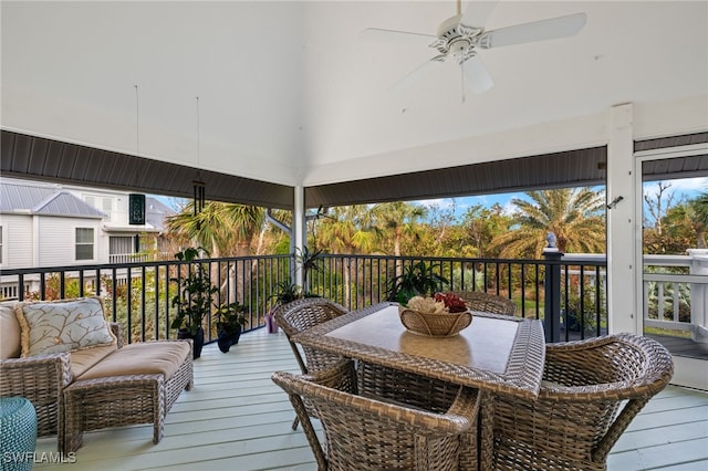 wooden terrace with an outdoor hangout area and a ceiling fan