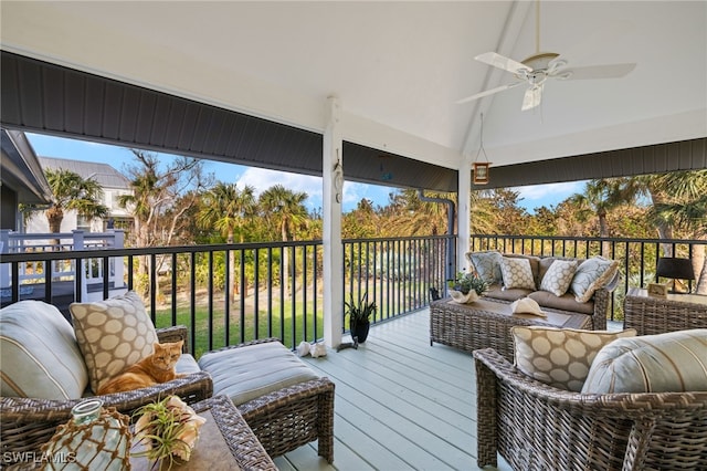 wooden deck with an outdoor living space and a ceiling fan