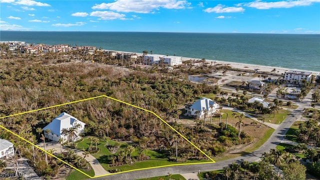 bird's eye view featuring a beach view and a water view