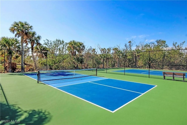 view of tennis court featuring fence