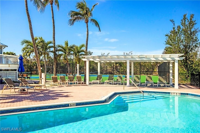 community pool featuring a patio area, fence, and a pergola