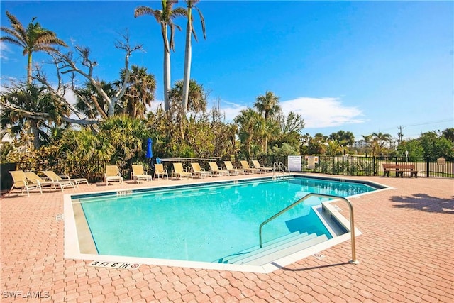 pool featuring a patio area and fence