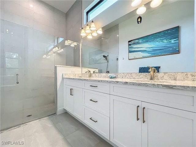 bathroom with vanity and a shower with shower door