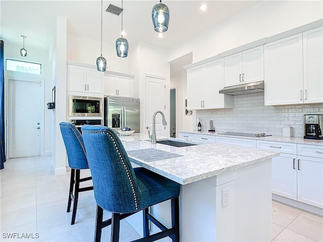 kitchen with white cabinetry, sink, an island with sink, and appliances with stainless steel finishes