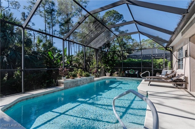 view of pool with a lanai and a patio area