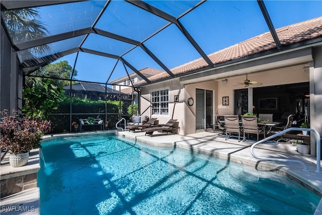 view of pool with a lanai, ceiling fan, and a patio area