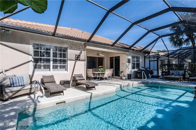 view of pool featuring ceiling fan, a lanai, and a patio