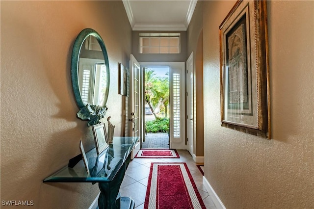 16144 Parque Ln, Naples, FL 34110 - entryway with a textured wall, crown molding, baseboards, and tile patterned floors