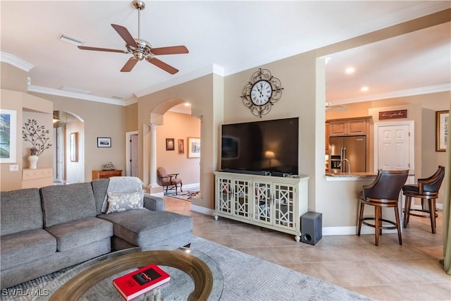 16144 Parque Ln, Naples, FL 34110 - living area with ceiling fan, arched walkways, crown molding, light tile patterned floors, and baseboards