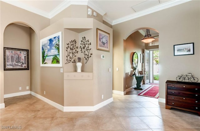 foyer entrance with light tile patterned flooring and ornamental molding