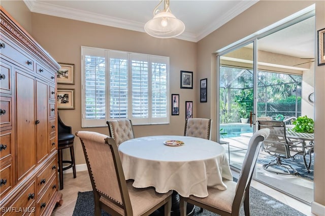 dining room featuring a healthy amount of sunlight, light tile patterned flooring, and ornamental molding