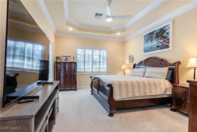 bedroom featuring light colored carpet, a raised ceiling, ceiling fan, and crown molding